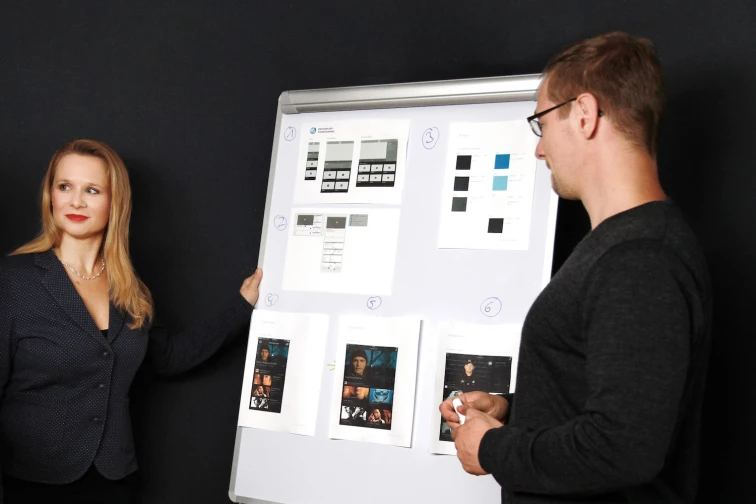  man and woman infront of a whiteboard